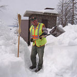 Maintenance worker Gary Maki shovels a path through deep snow to