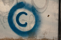 Large copyright graffiti sign on cream colored wall